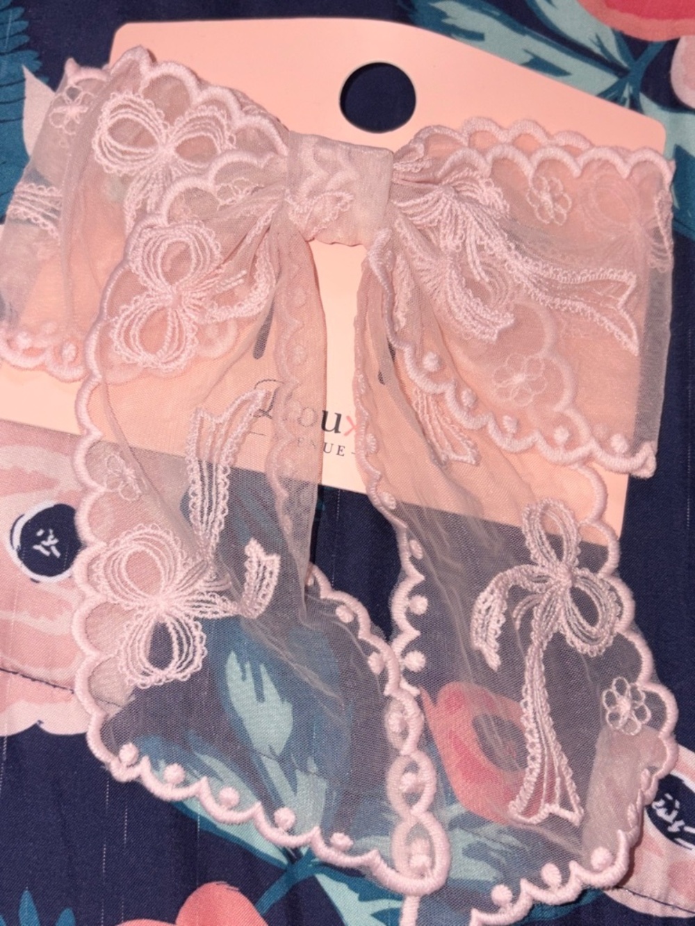 Pink lace bow with floral embroidery detail